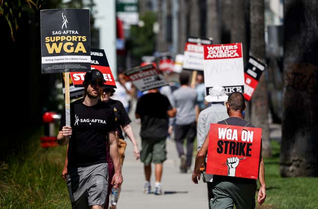 A sign reads ‘SAG-AFTRA Supports WGA’ as SAG-AFTRA members walk the picket line in solidarity with striking WGA (Writers Guild of America) workers outside Netflix offices on July 11, 2023 in Los Angeles, California