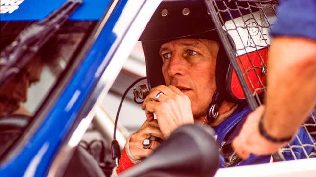 Paul Newman prepares for the start of a race