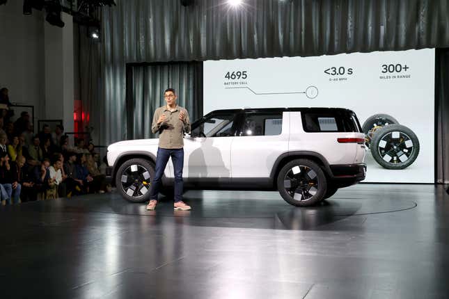 Rivian CEO RJ Scaringe in March alongside the automaker’s new R2 mid-size SUV.