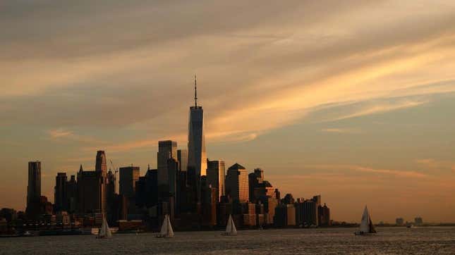 The Sun sets on the skyline of lower Manhattan and One World Trade Center in New York City on October 26, 2023, as seen from Hoboken, New Jersey. 