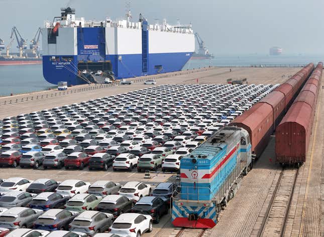 FILE - A freight train carrying cars to be exported arrives at a dock for ro-ro shipping in Yantai in eastern China&#39;s Shandong province Sunday, March 3, 2024. China’s exports contracted in March after growing in the first two months of the year, underscoring the uneven nature of the country&#39;s recovery from the pandemic. (Chinatopix via AP, File)