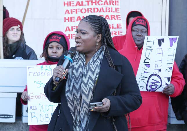 WASHINGTON, DC - DECEMBER 12: Rep. Cori Bush (D-MO), center, joins Maximus Federal Call Center workers at a protest calling on the Biden Administration for higher wages and good federal jobs outside the Department of Health and Human Services (HHS) on December 12, 2023 in Washington, DC. 