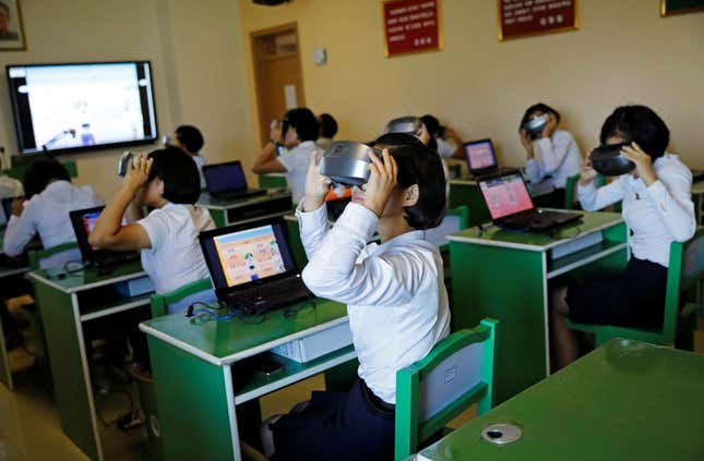 Students at a teachers’ training college use VR glasses during a government-organized visit.
