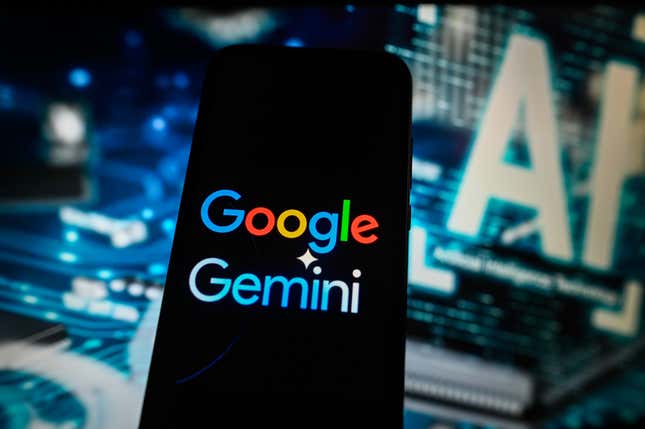 A Google Gemini logo is displayed on a smartphone with an “artificial intelligence” symbol in the background.
