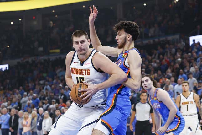 Oct 29, 2023; Oklahoma City, Oklahoma, USA; Denver Nuggets center Nikola Jokic (15) drives to the basket against Oklahoma City Thunder forward Chet Holmgren (7) during the first quarter at Paycom Center.