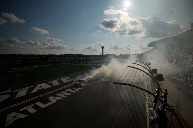 Chase Elliott, driver of the No. 9 NAPA Auto Parts Chevrolet, celebrates with a burnout after winning the NASCAR Cup Series Quaker State 400 at Atlanta Motor Speedway on July 10, 2022 in Hampton, Georgia. 