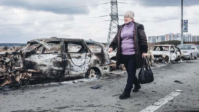 IRPIN, UKRAINE - MARCH 07: A woman walks in front of burned cars on a bridge in Irpin, on March 7, 2022, in Irpin, Ukraine. The Ukrainian army is resisting for the moment the heavy Russian siege in some of its cities, such as Irpin and Kiev, where fighting is intensifying. The United Nations estimates that the number of Ukrainian refugees could reach 1.5 million. 