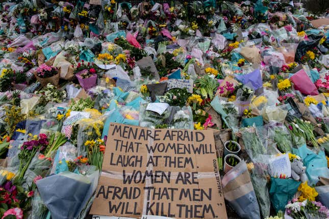 Flowers and signs at a London memorial for Sarah Everard in London.