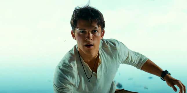 Tom Holland as Nathan Drake in Uncharted, standing on an open cargo platform. 