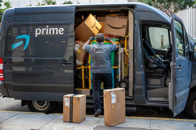 A worker delivers Amazon packages on Cyber Monday in San Francisco, California, US, on Monday, Nov. 27, 2023.