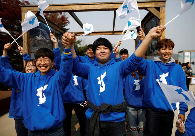 People wave the Korean unification flag during the summit near the DMZ separating the two Koreas, in Paju, South Korea.