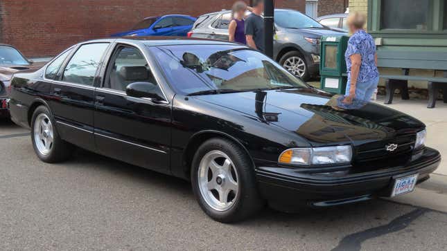 A black 1996 Impala SS parked on a street