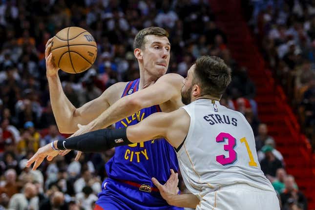 Feb 13, 2023; Miami, Florida, USA; Denver Nuggets forward Vlatko Cancar (31) protects the basketball from Miami Heat guard Max Strus (31) during the third quarter at Miami-Dade Arena.