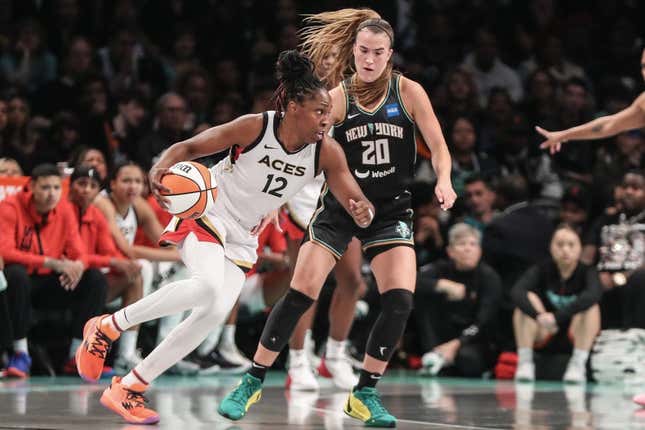 Oct 15, 2023; Brooklyn, New York, USA; Las Vegas Aces guard Chelsea Gray (12) drives around New York Liberty guard Sabrina Ionescu (20) in the third quarter during game three of the 2023 WNBA Finals at Barclays Center.