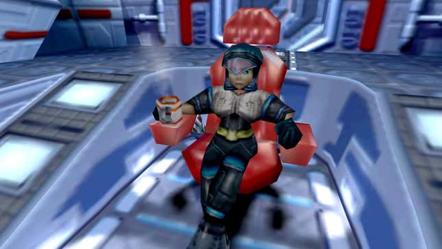 June is sitting in a red chair on a spaceship, drinking some kind of hot drink from a red and white mug.