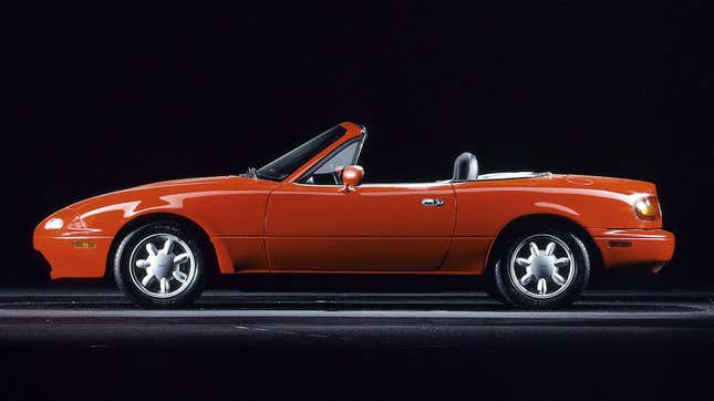 Mazda press image of a red NA MX-5 Miata in profile.