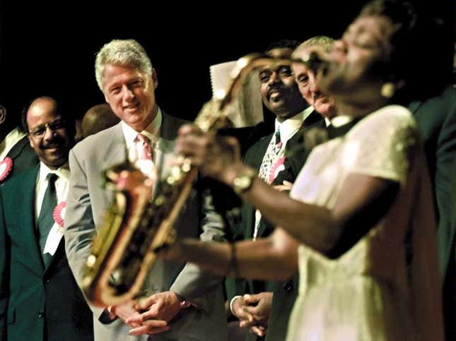 ORLANDO, UNITED STATES: US President Bill Clinton (C) , Reverend Henry Lyons(L), and Reverend Roscoe Cooper(3rd L) watch church member Angella Christi play a solo on her saxaphone 06 September during the National Baptist Convention in Orlando, Florida. The President is on a two-day campaign swing in Florida. (ELECTRONIC IMAGE) AFP PHOTO by Paul RICHARDS