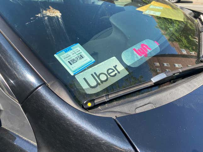 A windshield with driving app stickers