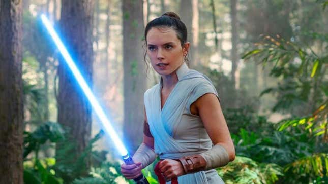 Rey holds a lightsaber 