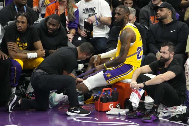 Nov 10, 2023; Phoenix, Arizona, USA; Los Angeles Lakers forward LeBron James (23) gets medical attention in a timeout against the Phoenix Suns in the first half at Footprint Center.