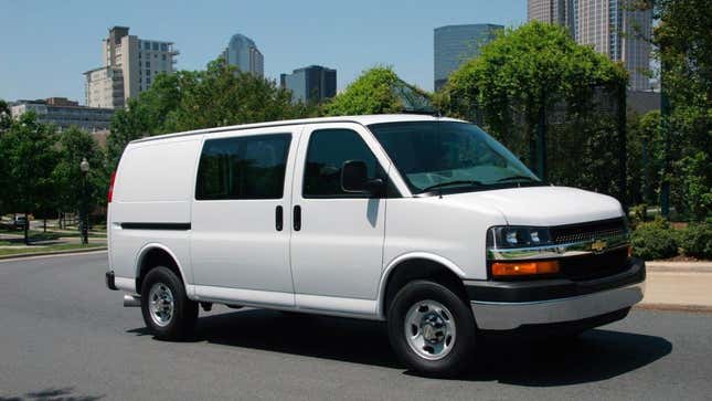 A Chevy Express van in white parked in a city