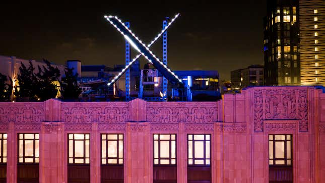Workers install lighting on an “X” sign atop the company headquarters, formerly known as Twitter, in downtown San Francisco, July 28, 2023.