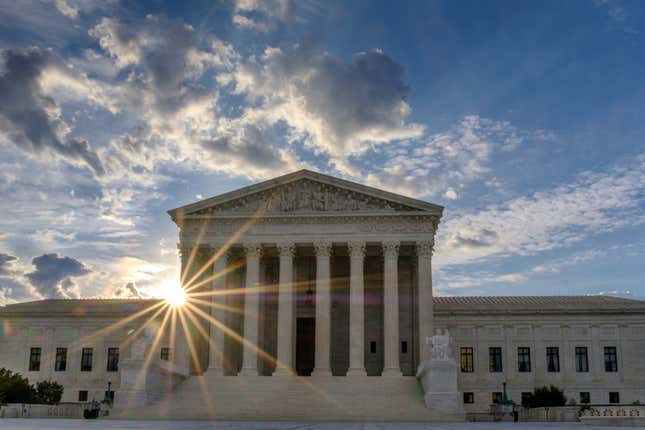 FILE - The sun flares in the camera lens as it rises behind the U.S. Supreme Court building in Washington, June 25, 2017. The Supreme Court will hear an appeal from a Vista, Calif., CBD hemp oil company fighting a lawsuit from a truck driver who says he got fired after using a product falsely advertised as being free from the active ingredient in marijuana.(AP Photo/J. David Ake, File)