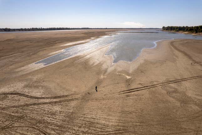 James Isaacks walks where the normally wide Mississippi River would flow, Oct. 20, 2022, near Portageville, Mo.
