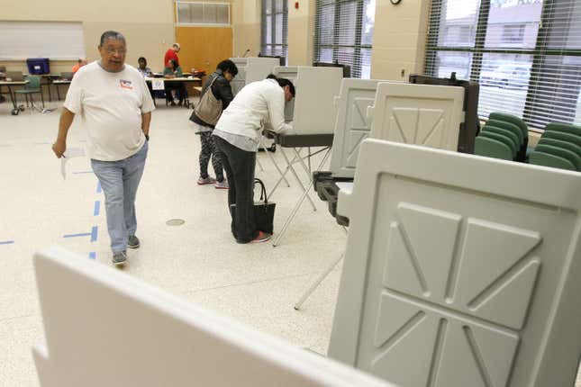 Joe Ford of Biloxi, Miss., walks to a voting booth at the Donal Snyder Community Center in Biloxi to cast his ballot in the presidential primaries on Tuesday, March 8, 2016. 