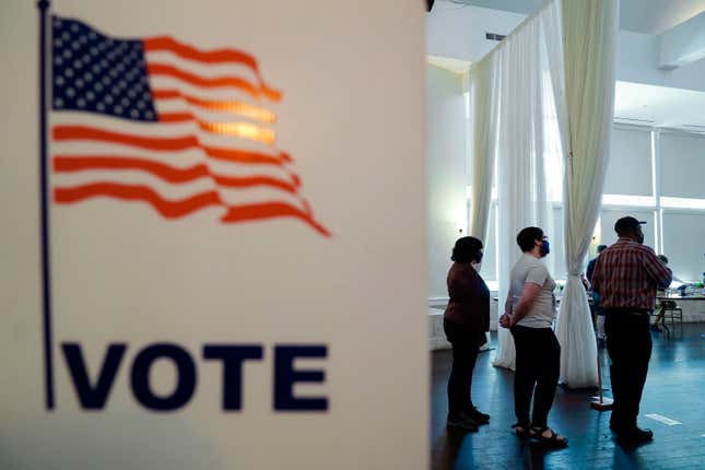 People wait in line to vote in the Georgia’s primary election on Tuesday, May 24, 2022, in Atlanta. 