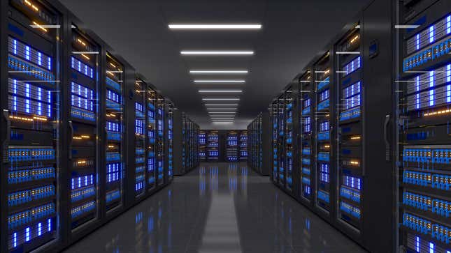 a hallway of server racks lit up in blue in a dark data center