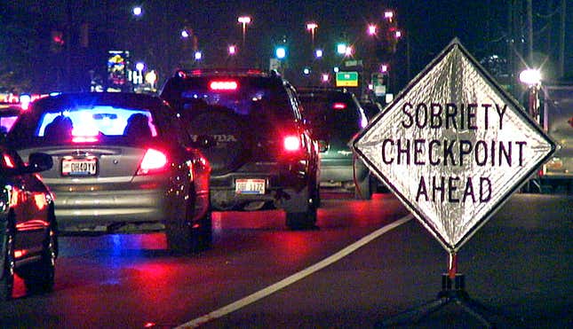 FILE - A sign warns motorists as they approach a sobriety checkpoint on State Route 4 in Fairfield, Ohio June 15, 2007. U.S. auto safety regulators say they have taken the first step toward requiring devices in vehicles that prevent drunk or impaired driving. The National Highway Traffic Safety Administration announced on Tuesday, Dec. 12, 2023, that it is starting the process to put a new federal safety standard in place requiring the technology in all new passenger vehicles. (AP Photo/The Enquirer, Glenn Hartong, File)/The Cincinnati Enquirer via AP, File)