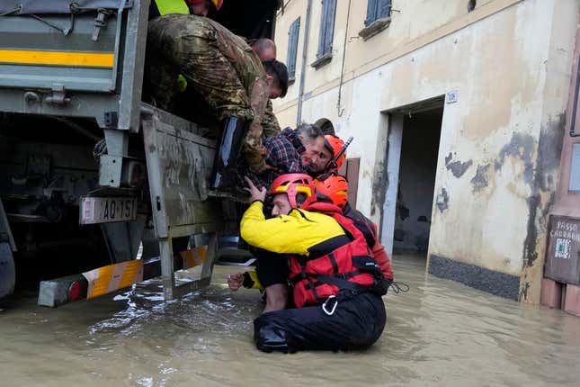 FILE - Firefighters rescue an elderly man in the flooded village of Castel Bolognese, Italy, on May 17, 2023. Europe is facing growing climate risks and is unprepared for them, the European Environment Agency said in its first-ever risk assessment for the bloc Monday, March 11, 2024. (AP Photo/Luca Bruno, File)