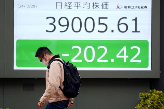 A person walks in front of an electronic stock board showing Japan&#39;s Nikkei 225 index at a securities firm Thursday, Feb. 29, 2024, in Tokyo. Shares were mixed in Asia on Thursday after a lackluster day on Wall Street, where selling of technology stocks pulled benchmarks lower. (AP Photo/Eugene Hoshiko)