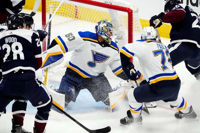 Nov 1, 2023; Denver, Colorado, USA; St. Louis Blues goaltender Jordan Binnington (50) makes a save on Colorado Avalanche right wing Logan O&#39;Connor (25) as defenseman Justin Faulk (72) defends in the first period at Ball Arena.