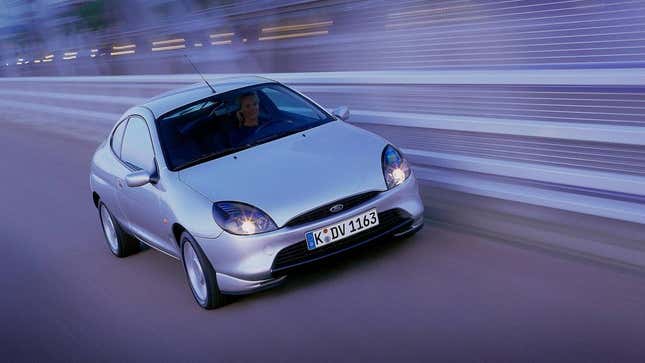 A silver Ford Puma on a racetrack