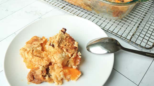 A scoop of peach cake on a plate.