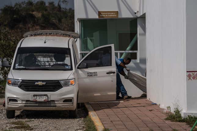 Funeral home workers pull the body of a hurricane Otis victim at a morgue in Acapulco, Mexico, Sunday, Oct. 29, 2023. Mexican authorities have raised the toll to 48 dead from the Category 5 storm that struck the country&#39;s southern Pacific coast. (AP Photo/Felix Marquez)