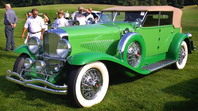 Automotive enthusiasts admire a stunning1929 Duesenberg Model J Murphy convertible sedan at the Meadow Brook Hall Concours D'elegance August 3, 2003 in Rochester Hills, Michigan.
