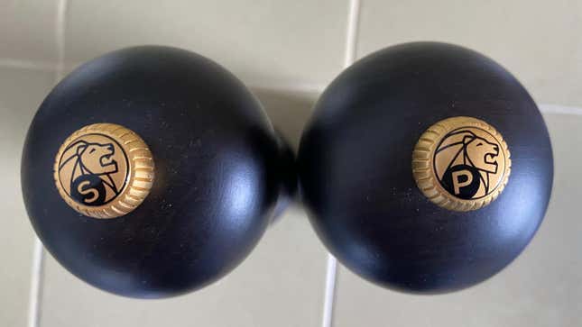 A top-down view of the Peugeot salt and pepper mills on a kitchen counter