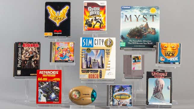 Multiple video game disc cases and cartridges in front of a grey background
