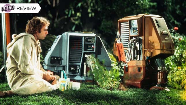 Bruce Dern sits on grass with robots in a scene from sci-fi classic Silent Running.