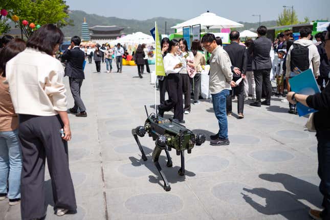 Citizens are watching a demonstration of the Vision 60 UGV by Ghost Robotics in Seoul, South Korea. 