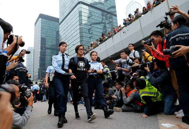 Singer and actress Denise Ho is taken away by policewomen in Hong Kong in 2014.