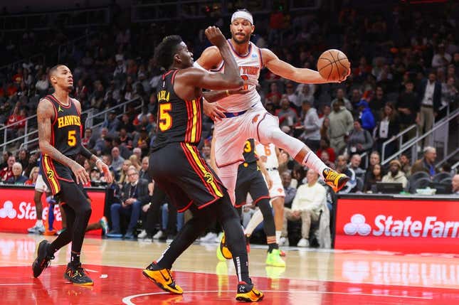 Nov 15, 2023; Atlanta, Georgia, USA; New York Knicks guard Josh Hart (3) passes around Atlanta Hawks center Clint Capela (15) in the first quarter at State Farm Arena.