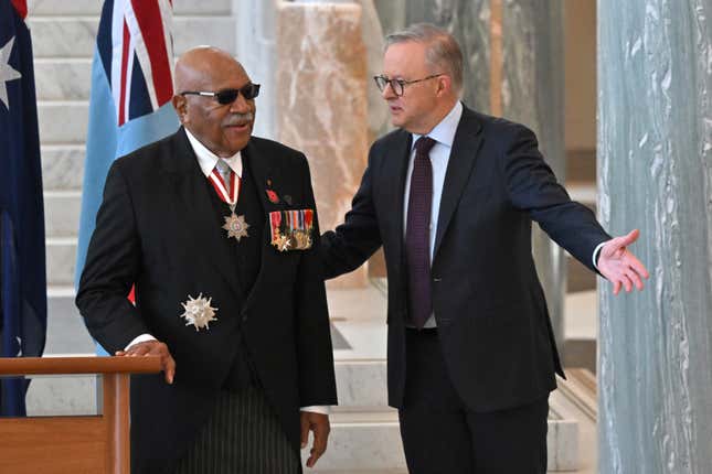 Fiji&#39;s Prime Minister Sitiveni Rabuka, left, and Australian Prime Minister Anthony Albanese talk after signing the visitors&#39; book at Parliament House in Canberra, Wednesday, Oct. 18, 2023. Rabuka said his government was &quot;more comfortable dealing with traditional friends&quot; such as Australia as China pursues closer security ties in the Asia-Pacific region. (Mick Tsikas/AAP Image via AP)