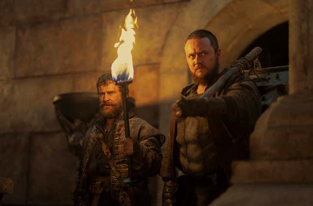 Two bearded men stand, one with a torch, one with a club slung over his shoulder, in an image from HotD S2 E1. 