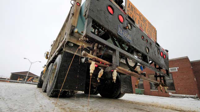 In a demonstration, a Pennsylvania Department of Transportation anti-icing truck sprays a de-icing cocktail of brine and beet juice on the driveway of PennDot’s Butler, Pa., maintenance facility.