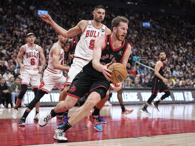 Apr 12, 2023; Toronto, Ontario, CAN; Toronto Raptors center Jakob Poeltl (19) recovers a loose ball against Chicago Bulls center Nikola Vucevic (9) during the second half of a NBA Play-In game at Scotiabank Arena.