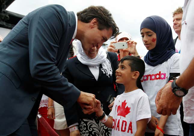 Shaking hands with a Syrian refugee child on Canada Day.